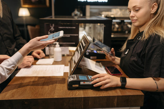 Photo by Pavel Danilyuk: https://www.pexels.com/photo/a-woman-in-black-shirt-using-a-payment-terminal-at-the-counter-6612714/